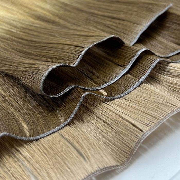 Stack of ultra-thin Genius Weft Hair Extensions made from 100% double drawn Remy human hair